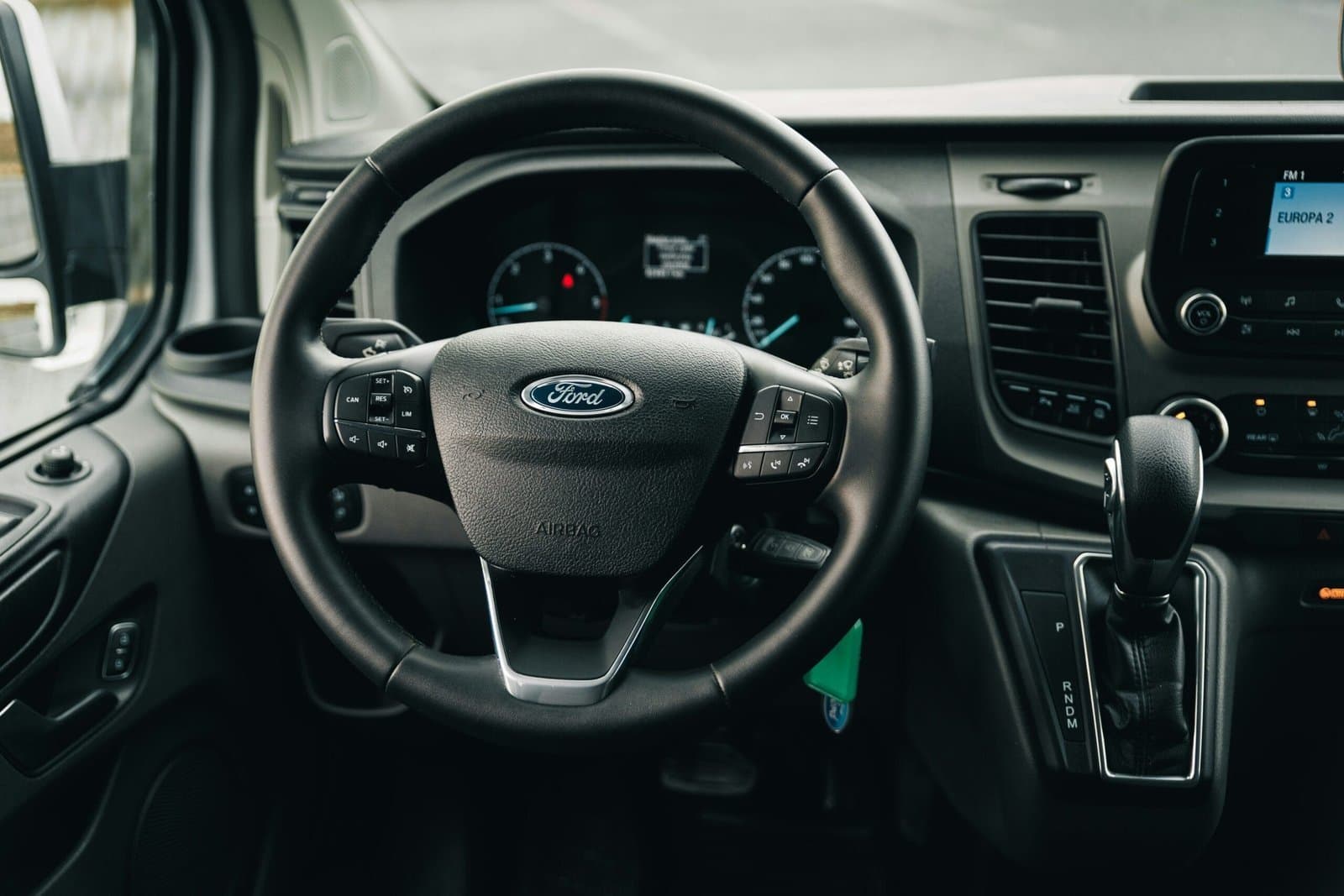 the interior of a car with a steering wheel and dashboard